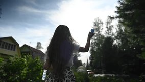 Little girl plays with soap bubbles outdoors. Video 360 degrees. Slow motion. 