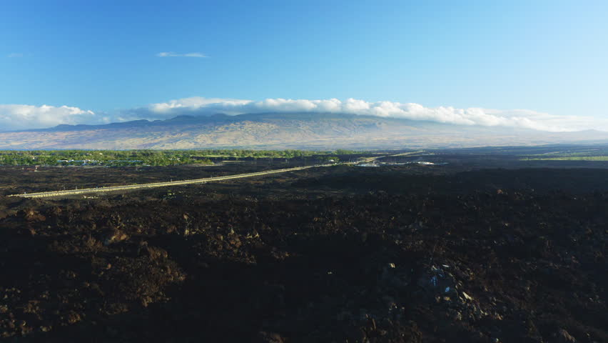 Aerial Drone Flyover Black Volcanic Rock Terrain Towards King Kamehameha Highway Road Hawaii, 4K