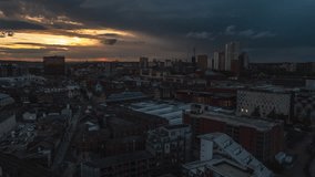 Establishing Aerial View Shot of Leeds UK, West Yorkshire, England United Kingdom, extrodinary dramatic sunset, track back reveal