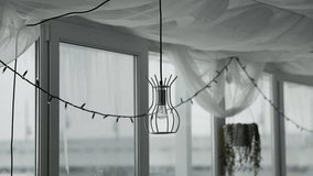 Modern wire lamps in interior of cafe against background large panoramic windows - Powered by Shutterstock - Get 15% off with code: PIKWIZARD15