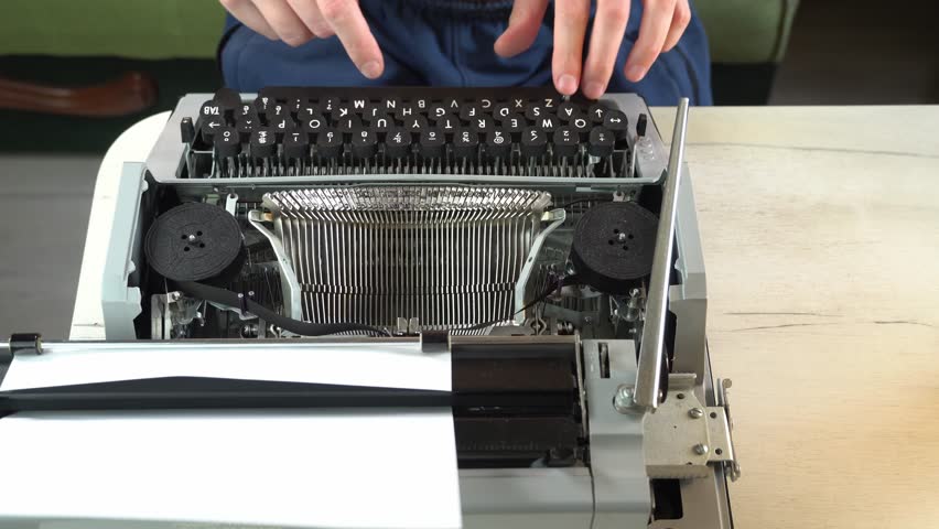 Writing a book and typing old typewriter, top view. Man typing on old vintage retro typewriter. News, media or communication concept