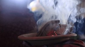 Hindu puja elements and a clay pot with coconut husks. Traditional Hindu Dhunuchi with a lot of smoke footage. Dhunuchi close-up footage and smoke. Holy worship elements video in Hindu religion.