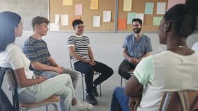 Teenager High School students talking to young teacher - Group support conversation in Higher Education - Powered by Shutterstock - Get 15% off with code: PIKWIZARD15