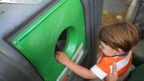 Little boy recycling glass into city recycle dispenser - Powered by Shutterstock - Get 15% off with code: PIKWIZARD15
