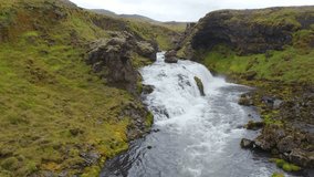 4k drone forward video (Ultra High Definition) of waterfall on Skoga river. Splendid summer view from the tourist trek from famous Skogafoss waterfall to the top of the river, Iceland, Europe.
