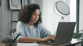 Busy worker freelancer working on modern tech device. Focused business woman entrepreneur typing on laptop doing research. Mixed race female professional using computer sitting at home office desk 4K - Powered by Shutterstock - Get 15% off with code: PIKWIZARD15