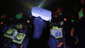 Young woman in VR headset looking around to abstract cyber world and neon social media icons. Girl wearing virtual or augmented reality 3D glasses at glowing background. Immersing in metaverse - Powered by Shutterstock - Get 15% off with code: PIKWIZARD15