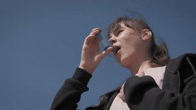 Girl with asthma against sky. A young girl suffer from asthma in summer. A concept of breathing and health trouble during childhood. - Powered by Shutterstock - Get 15% off with code: PIKWIZARD15