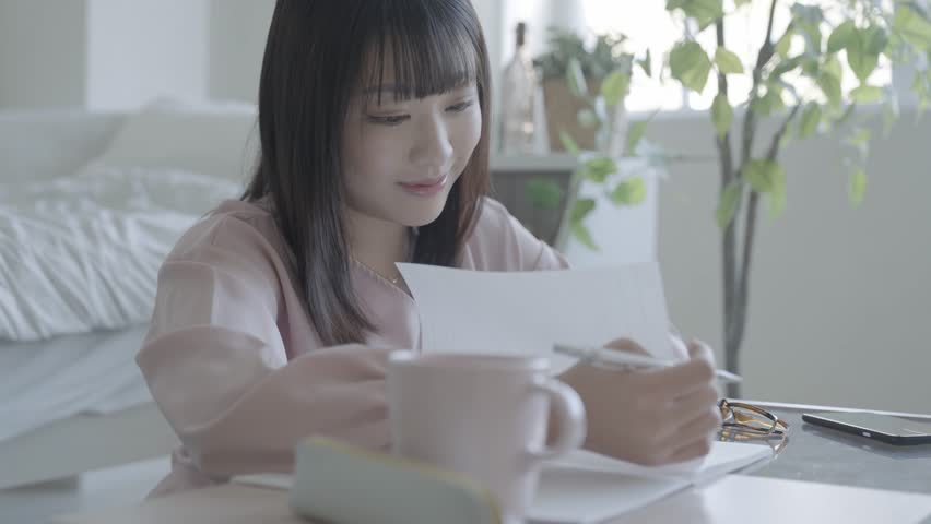 woman turning the pages of a notebook