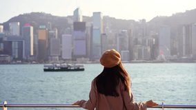 Young woman traveler relaxing and enjoying the sunset atmosphere at Victoria harbour in Hong Kong - Powered by Shutterstock - Get 15% off with code: PIKWIZARD15