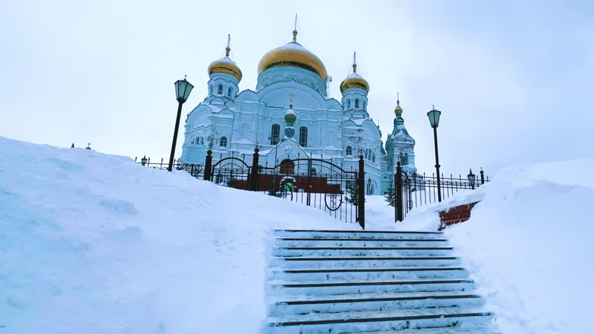 Belogorsky St. Nicholas Orthodox Missionary Monastery. Russia, Perm Krai, Belaya Gora. The temple on the hill in winter. Monastery on the background of snow. 4K