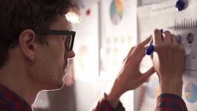 Businessman analyzing a graphic of a stock exchange chart. - Powered by Shutterstock - Get 15% off with code: PIKWIZARD15