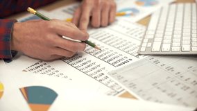 Businessman analyzing a graphic of a stock exchange chart. - Powered by Shutterstock - Get 15% off with code: PIKWIZARD15