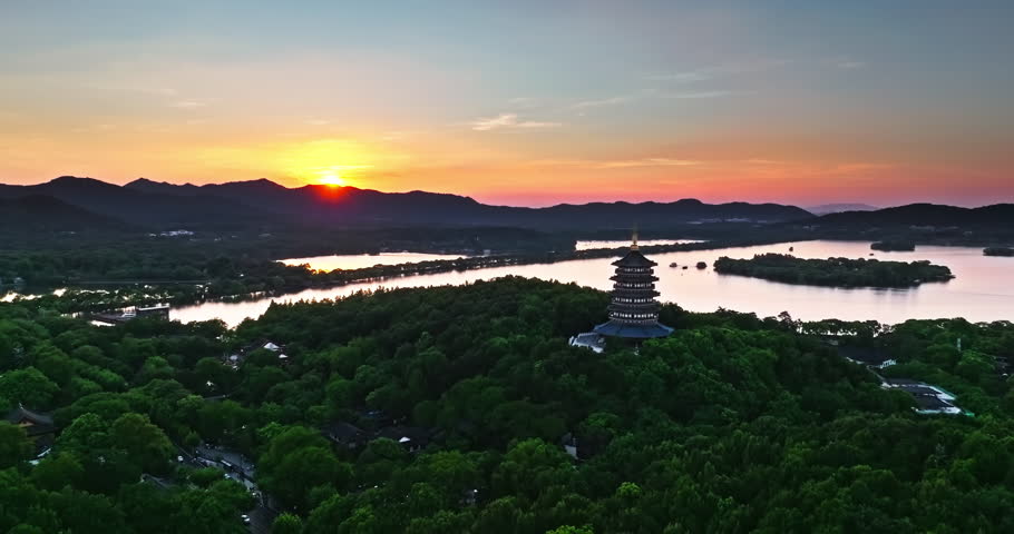 Aerial view of the beautiful West Lake natural scenery at sunset in Hangzhou, China. Ancient Leifeng Pagoda and the West Lake with mountain scenery in Hangzhou. 
