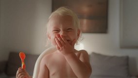 Funny little baby girl child eat porridge at home happy smiling infant kid newborn daughter son sit on feeding chair in kitchen laughing sincere laugh eating healthy food children nutrition childhood - Powered by Shutterstock - Get 15% off with code: PIKWIZARD15