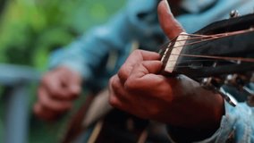 Closeup hand man play guitar. Video slowmotion