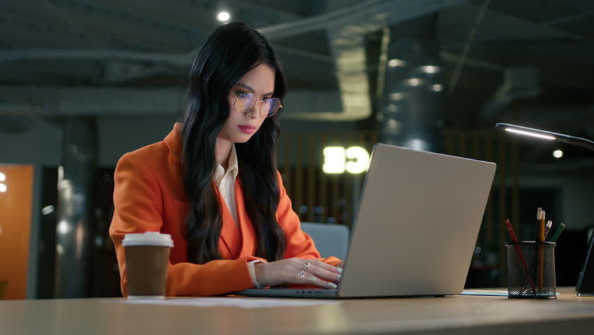Smart female in eyeglasses professional writing email at office. Dolly shot of confident focused asian mixed race brunette woman typing on laptop an email, closing computer, finishing work and leaving Royalty-Free Stock Footage #1102708649