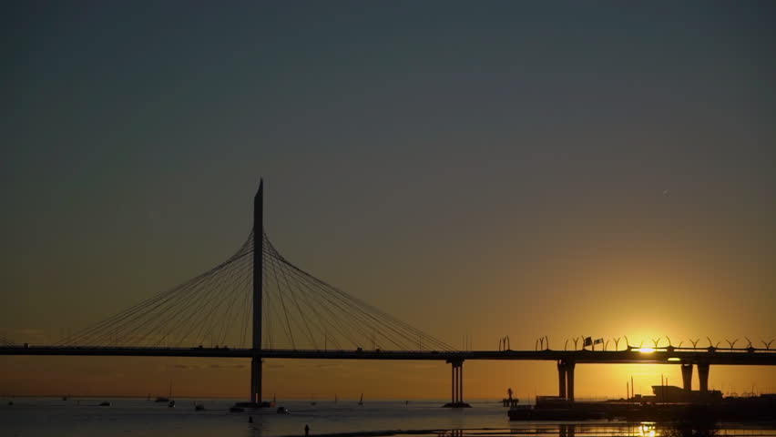 Modern cable-stayed bridge. A road across a river or sea. WHSD - western high-speed diameter in St. Petersburg, Russia. Yachts and boats are sailing. Sunset or sunrise.