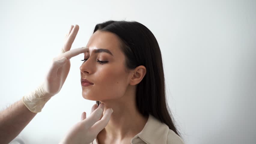 4k video ENT consultation before rhinoplasty plastic surgery. Rhinoplasty is surgical procedure that involves altering shape of nose to improve appearance and enhance breathing. Royalty-Free Stock Footage #1102715597