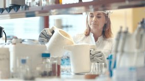 research with liquid nitrogen in the laboratory is carried out by a young female scientist with a protective glass face mask - Powered by Shutterstock - Get 15% off with code: PIKWIZARD15