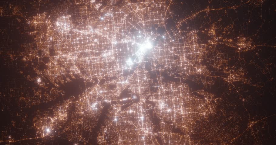 Dallas and Fort Worth (Texas, USA) aerial view at night. Top view on modern city with street lights. Camera is zooming out, rotating counterclockwise. Vertical video. The north is on the left side