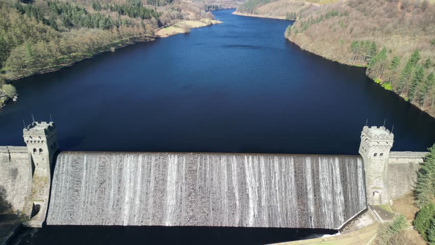 Aerial tilt up from the Derwent Dam to reveal the Derwent Reservoir and landscape, home of the Dam Busters practice during the second world war.