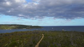 Time-lapse video of Sydney's bush and sea, clouds in the blue sky and movement of ships