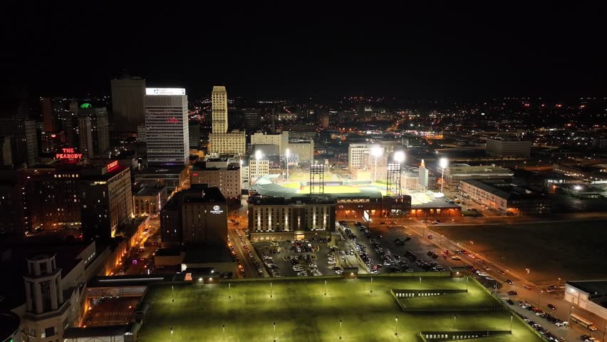 Memphis , TN , United States - 03 25 2023: Autozone Park, home of the minor league baseball team the Memphis Redbirds in Memphis, Tennessee at night with drone video moving forward.
