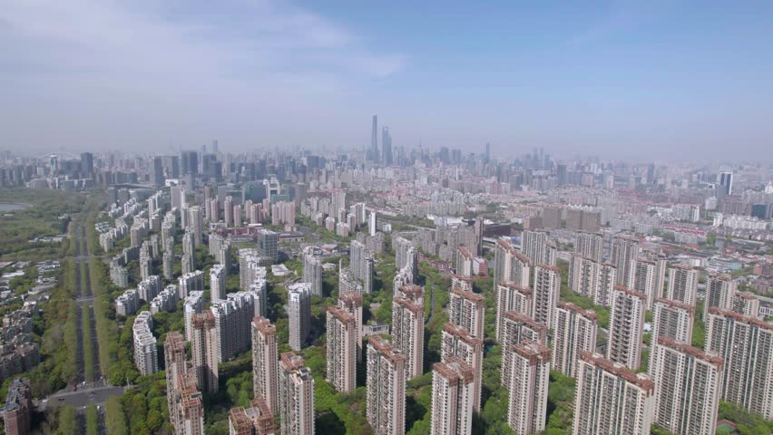 The drone aerial footage of residential district in Pudong with skyscrapers in the background, Shanghai, China. 