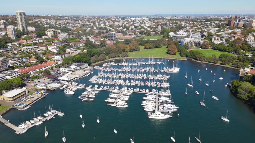 Aerial drone pullback reverse view of Rushcutters Bay in East Sydney, NSW Australia on a sunny day  Royalty-Free Stock Footage #1102746743