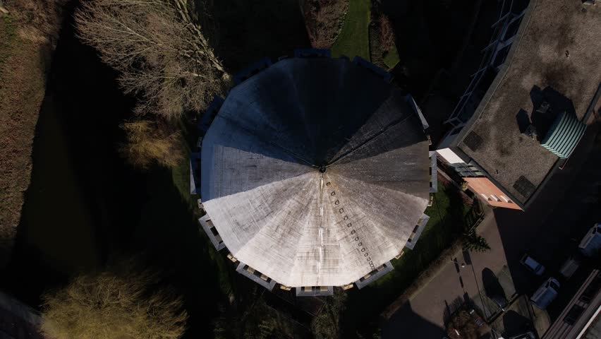 Top down aerial view of dome and reveal of former Dutch brick water tower in Zutphen. Architectural detail cityscape