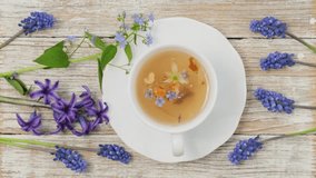 Tea Time: Relaxing with herbal tea with healing properties. Drink with natural herbs. Floral tea arrangement. Nature's remedy aromatic herbal tea with healing herbs and flowers top view vertical video