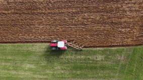 Tractor ploughing a meadow of green grass. View from above with a drone. - Powered by Shutterstock - Get 15% off with code: PIKWIZARD15
