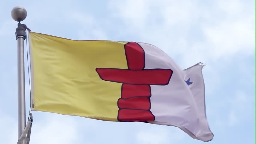 A waving of the Flag of Nunavut, a red inuksuk a traditional Inuit land marker and a blue star, which represents the Niqirtsuituq, the North Star, and the leadership of elders in the community.