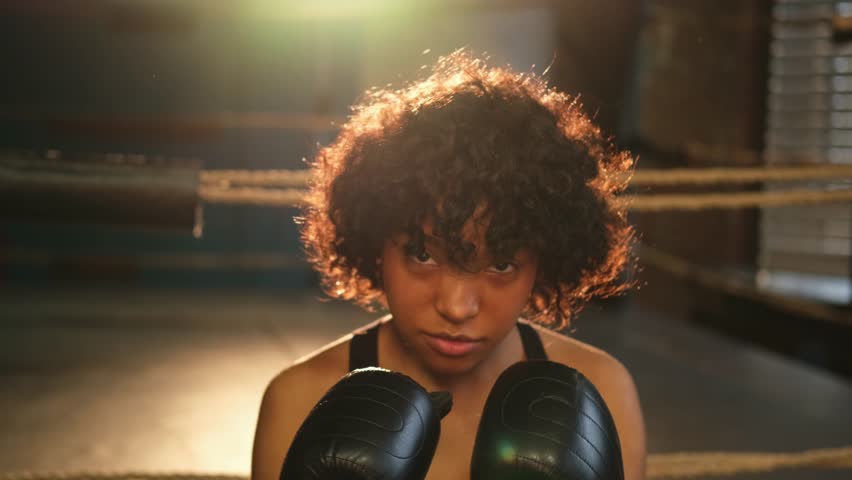 Outcry independent girl power. Angry african american woman fighter with boxing gloves looking serious aggressive to camera standing on boxing ring. Strong powerful girl looking concentrated straight Royalty-Free Stock Footage #1102762129