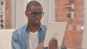 portrait of African Man Doing Video Chat on Tablet