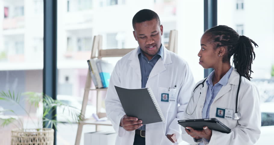 Documents, black people and doctors talking of hospital digital management, report or advice of manager for internship. Walking, tablet and medical professional woman with expert or mentor planning Royalty-Free Stock Footage #1102766111