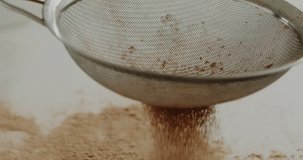 Macro close up tabletop chocolate powder fallin in slow motion