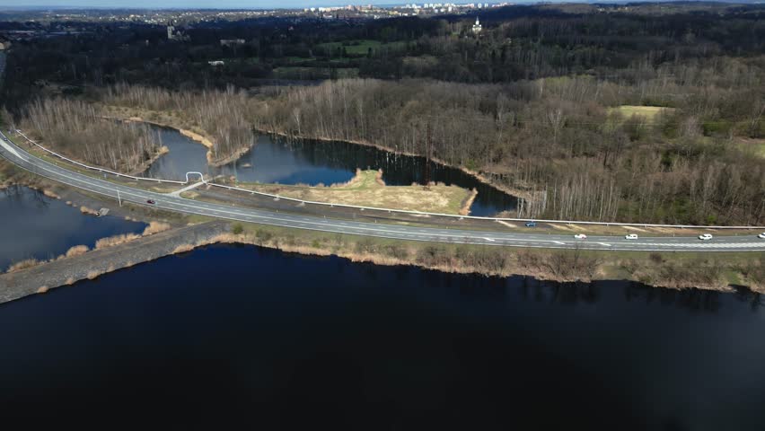 A scenic view from a drone of a road winding between lakes created by mine subsidence. North Moravia Region Karviná
