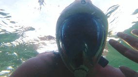 Male man with snorkeling mask wave underwater send greeting record video for social media in middle east persian gulf turquoise waters while on holidays vacation. Tourist pov