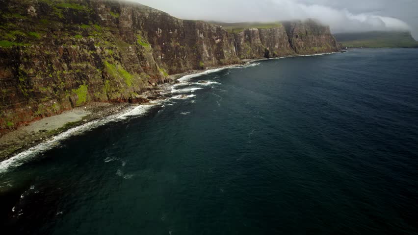Slow Lift Drone Shot Of Rough Green Coastline Cliffs In Isle Of Skye Scotland