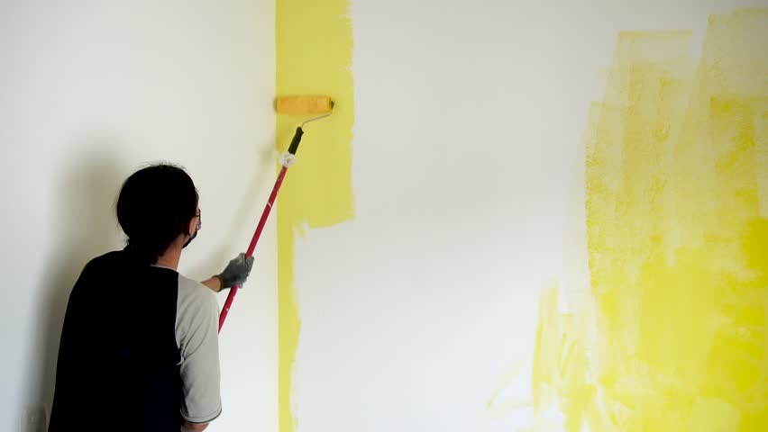 Renovation of spaces in the house. Person painting walls with a roller. worker applying paint to a wall with a roller. non-agricultural work visa for seasonal jobs Royalty-Free Stock Footage #1102778089