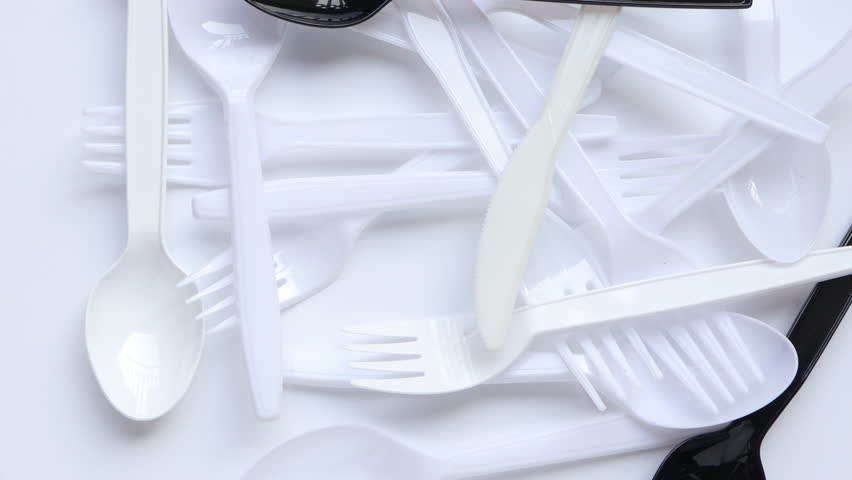 Disposable transparent plastic spoon and fork. Plastic spoon and fork rotating on white background. concept environmental problems. Royalty-Free Stock Footage #1102781281