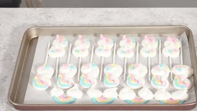 Time lapse. Step by step. Decorating freshly baked unicorn meringue pops cookies.