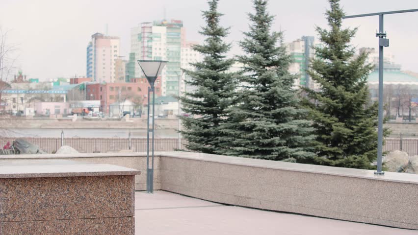 Happy young woman listens to music on headphones and dancing while on her way to work - she  using an online smartphone application. Slow motion 4k video.