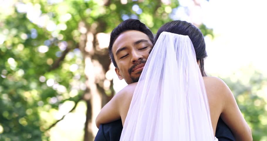 Park, wedding and man and woman hug for marriage ceremony, commitment and event in nature. Relationship, partnership and happy bride and groom in loving embrace for romance, celebration and love Royalty-Free Stock Footage #1102796771