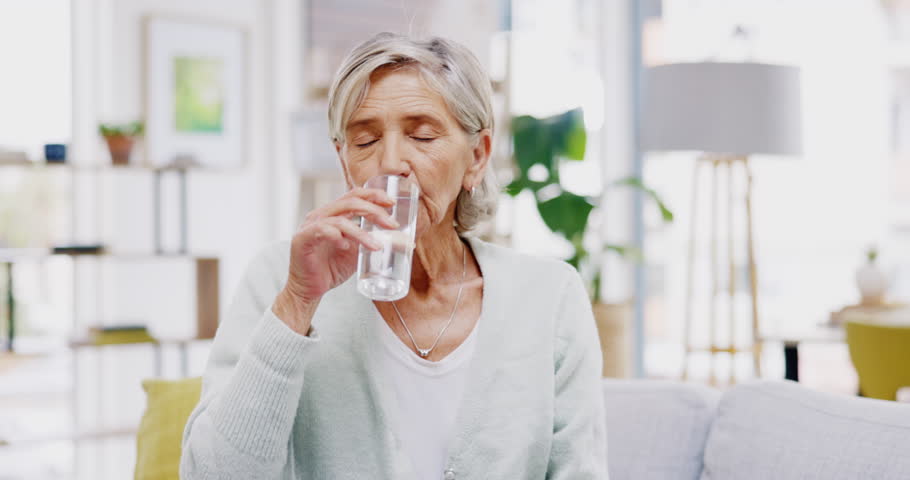 Wellness, home or healthy old woman drinking water for healthcare or natural vitamins in a house. Retirement, elderly relaxing or thirsty senior person refreshing with liquid for energy or hydration Royalty-Free Stock Footage #1102796775