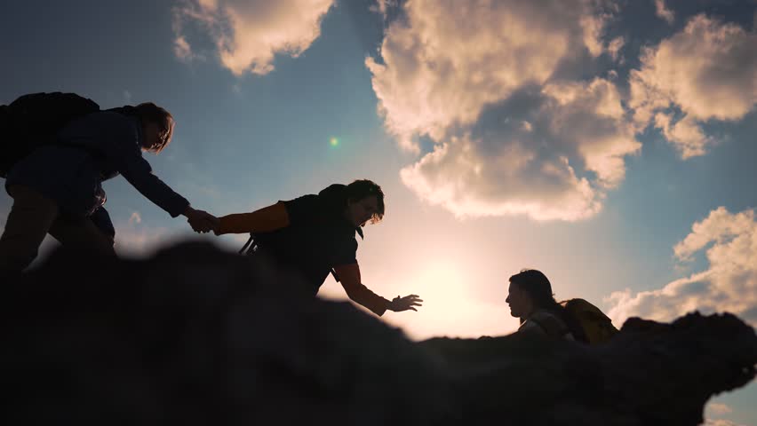 Helping hand in teamwork.Group of climbers daring climb to victory.People reach out to each other by hand providing help and support at every step of way.Power of teamwork.Together reach new heights Royalty-Free Stock Footage #1102798899