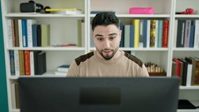 Young arab man student doing video call at university classroom