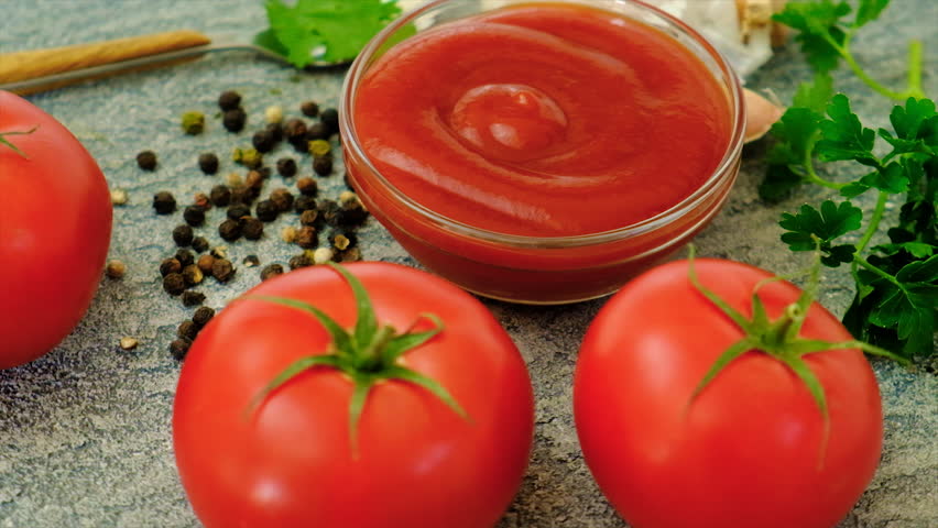 Ketchup and tomatoes on the table. Selective focus. Food.